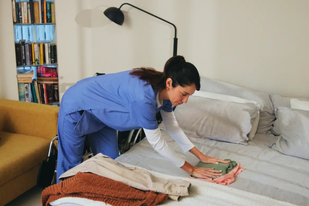 nurse making a bed for a patient