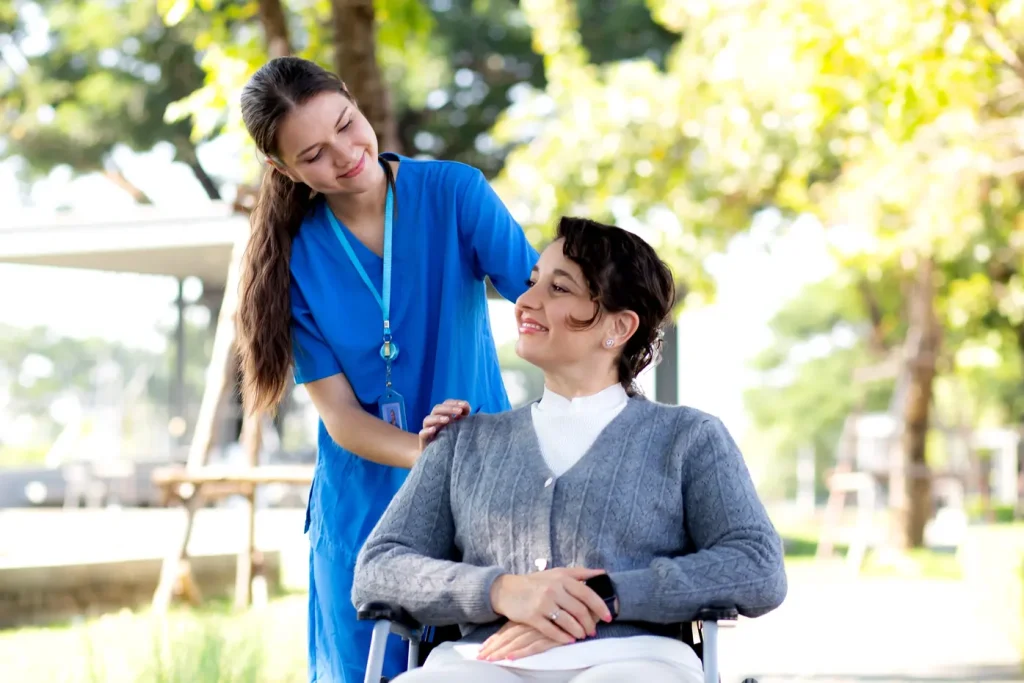 nurse with a women on wheel chair in park