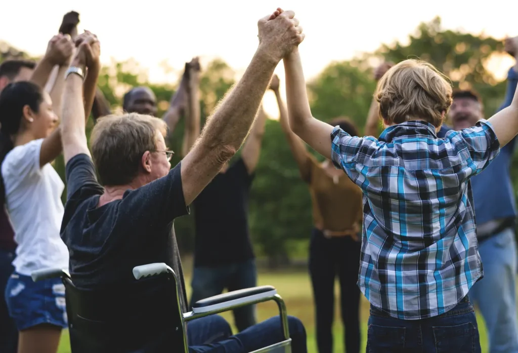 group of friends playing together with a disabled friend on wheel chair